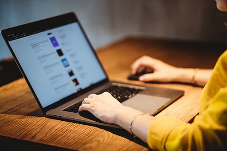 Frau am Laptop überlegt E-Mail-Adressen zu kaufen
