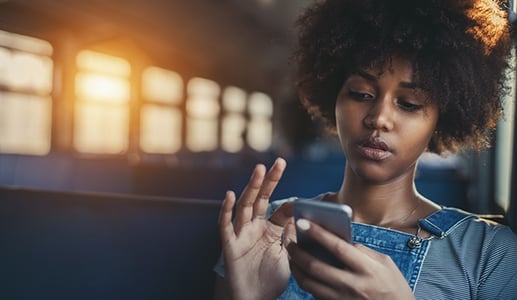 Frau am Smartphone erstellt Facebook Messenger Bot
